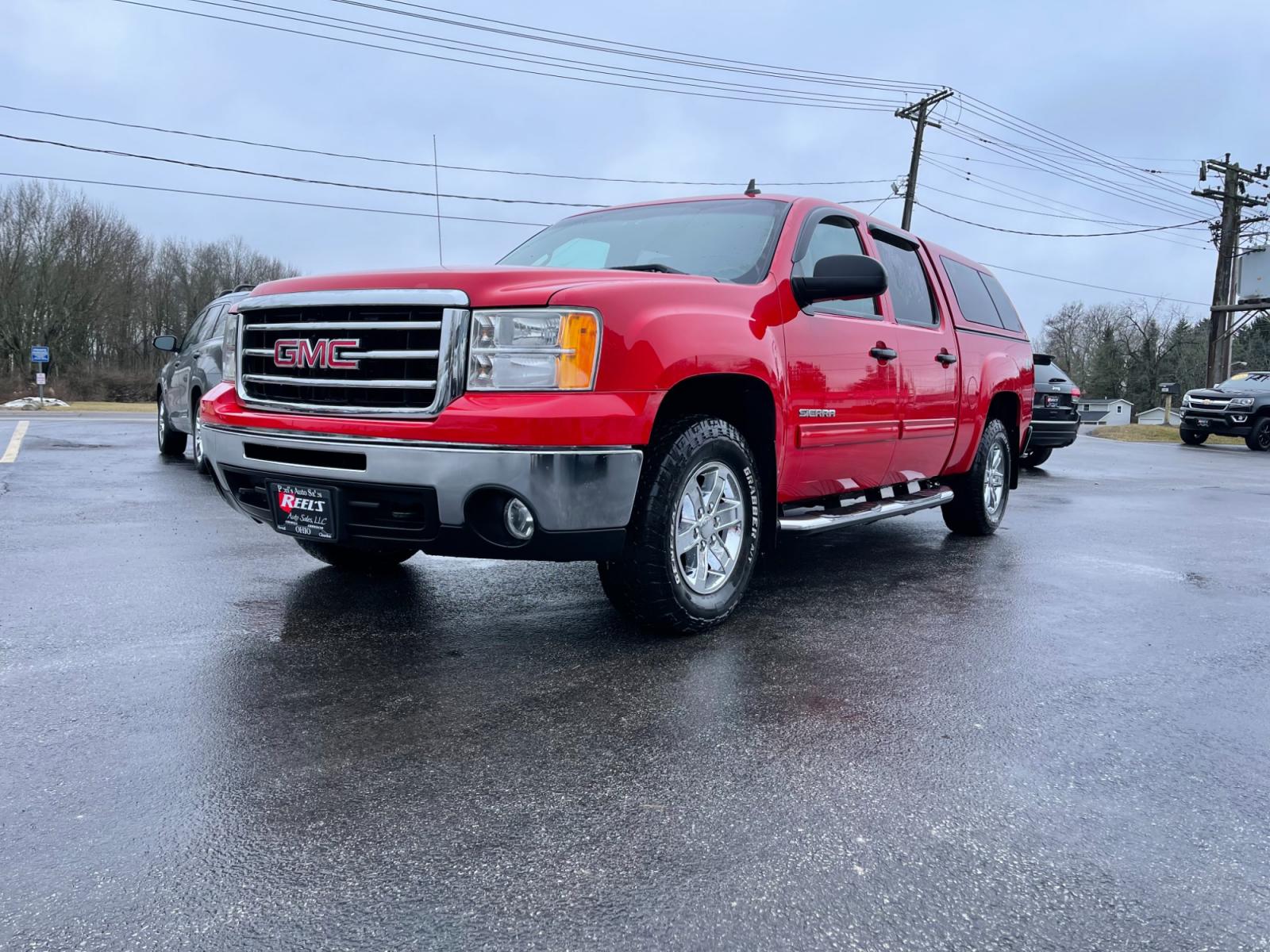 2012 Red /Black GMC Sierra 1500 SLE Crew Cab 4WD (3GTP2VE78CG) with an 5.3L V8 OHV 16V FFV engine, 6-Speed Automatic transmission, located at 11115 Chardon Rd. , Chardon, OH, 44024, (440) 214-9705, 41.580246, -81.241943 - This 2012 GMC Sierra 1500 SLE Crew Cab is a well-equipped full-size pickup truck with a robust 5.3-liter Vortec V8 engine, paired with a 6-speed automatic transmission, offering a generous towing capacity of 9,500 pounds. It features the Z71 Off-Road package for enhanced performance in varied terrai - Photo #0